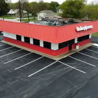 Aerial view of the Dairy Queen parking lot fully paved.